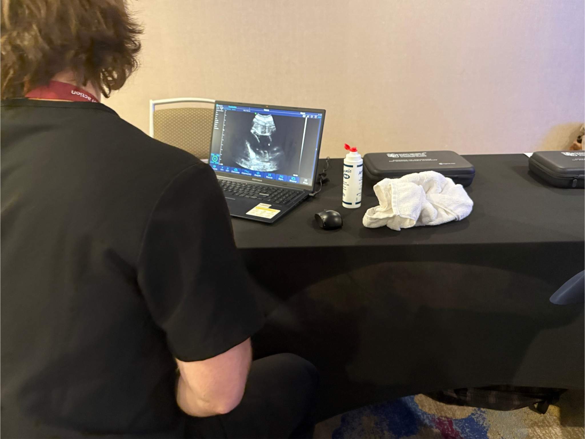 CAPA 2026 participant reviewing a live ultrasound image on a laptop during POCUS training